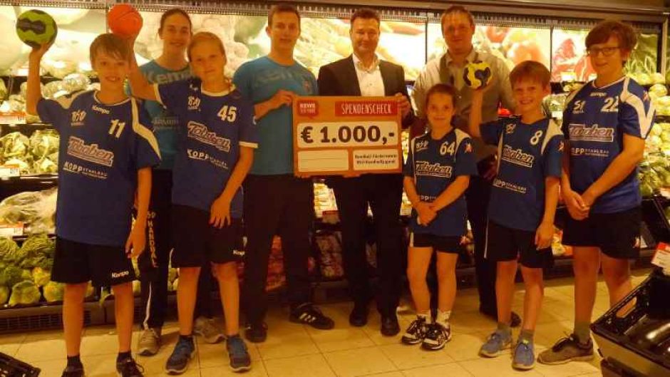 Bezirksleiter Ingo Boie und der stellvertretende Marktleiter Rony Braw im REWE-Markt in der Harburger Straße übergaben einen Scheck in Höhe von 1.000 Euro für den Handball-Förderverein. Gemeinsam mit einigen Nachwuchskräften und der deutschen Meisterin Svea Geist nahm BSV-Jugendkoordinator Lars Dammann die Spende entgegen. | Foto: ein