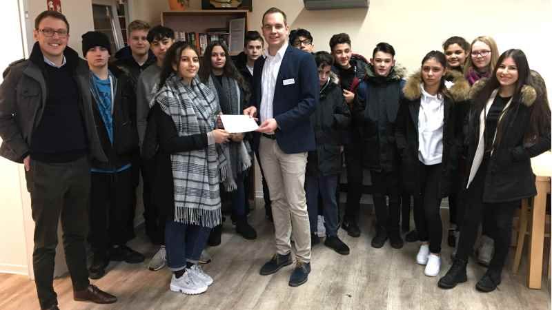 Schüler der Klasse M4 der Harburger Stadtteilschule im DRK-Harburg-Huus für Obdachlose bei der Spendenübergabe an Einrichtungsleiter Thorben Goebel-Hansen. | Foto: ein