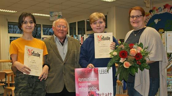 Strahlende Gesichter bei der Siegerehrung in der Bücherei des Buchholzer Albert-Einstein-Gymnasiums: Madlen Vita (von links, 3. Platz), Dr. Theo Fründt vom Verein Gewalt überwinden, Sieger Matti Westermann und Kunstlehrerin Wiebke Müller. | Foto: ein/Verein Gewalt überwinden e.V.