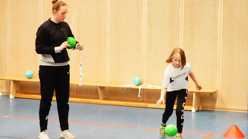 Spielerinnen der Handball-Luchse waren zu Gast beim Handball-Tag an der Grundschule Fischbek-Falkenberg - hier Torhüterin Zoe Ludwig mit der Fischbeker Viertklässlerin Liya beim Prellen. | Foto: Schule Fischbek-Falkenberg
